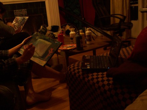 Painting by the fire on the couch in the living room on Christmas eve